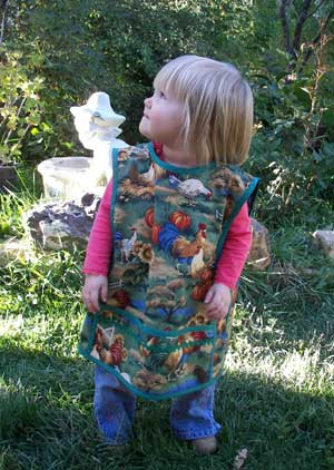 Small child in chicken garden